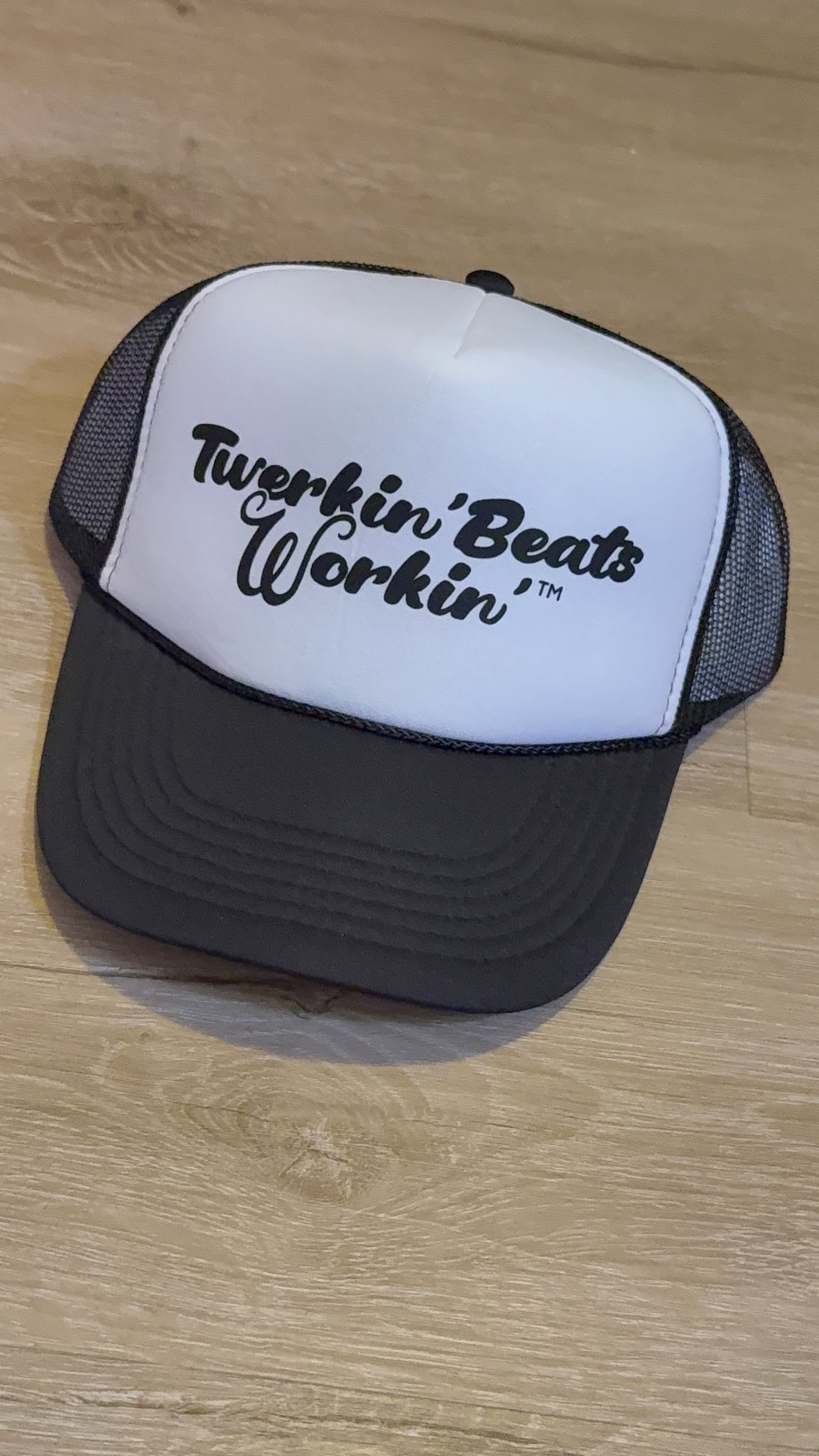 White and black hat with black Twerkin’ Beats Workin’ logo