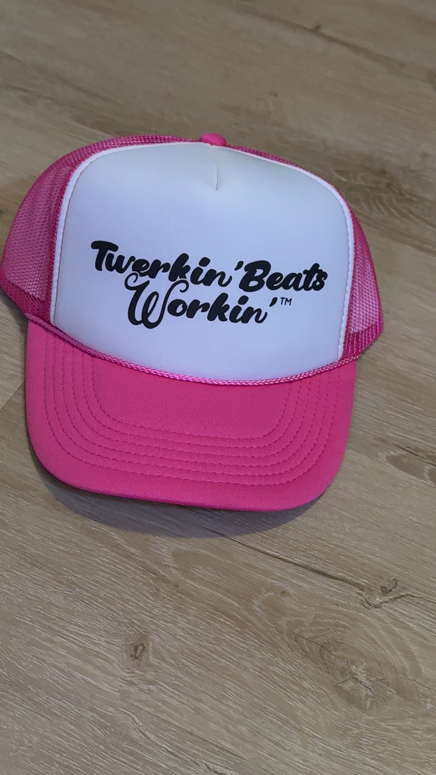 Pink and white with regular Twerkin’ Beats Workin’ in black logo