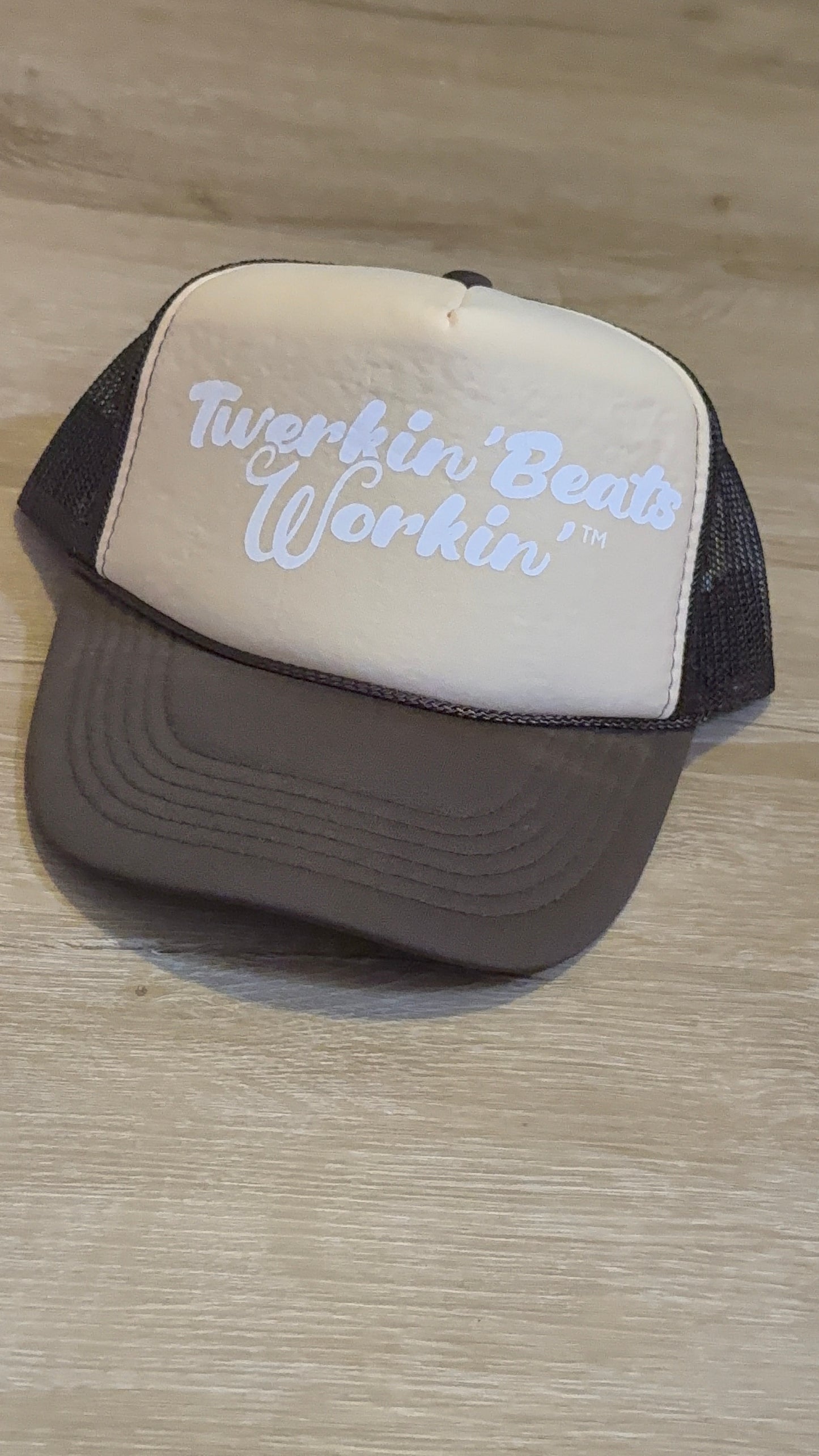 Tan and brown hat with white Twerkin’ Beats Workin’ logo