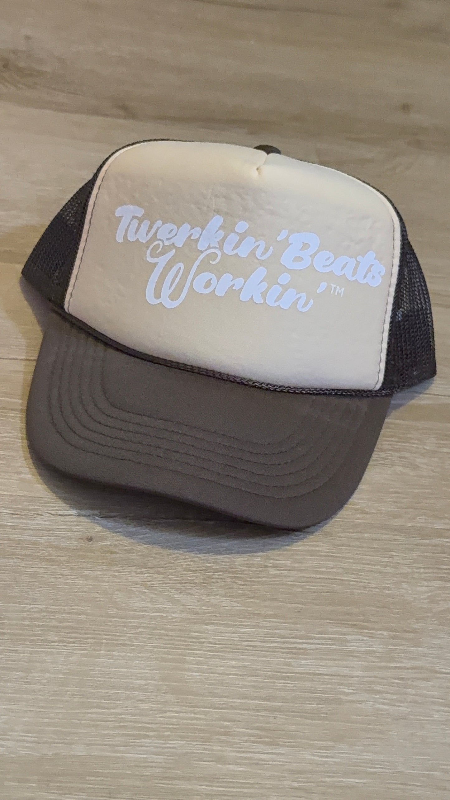 Tan and brown hat with white Twerkin’ Beats Workin’ logo