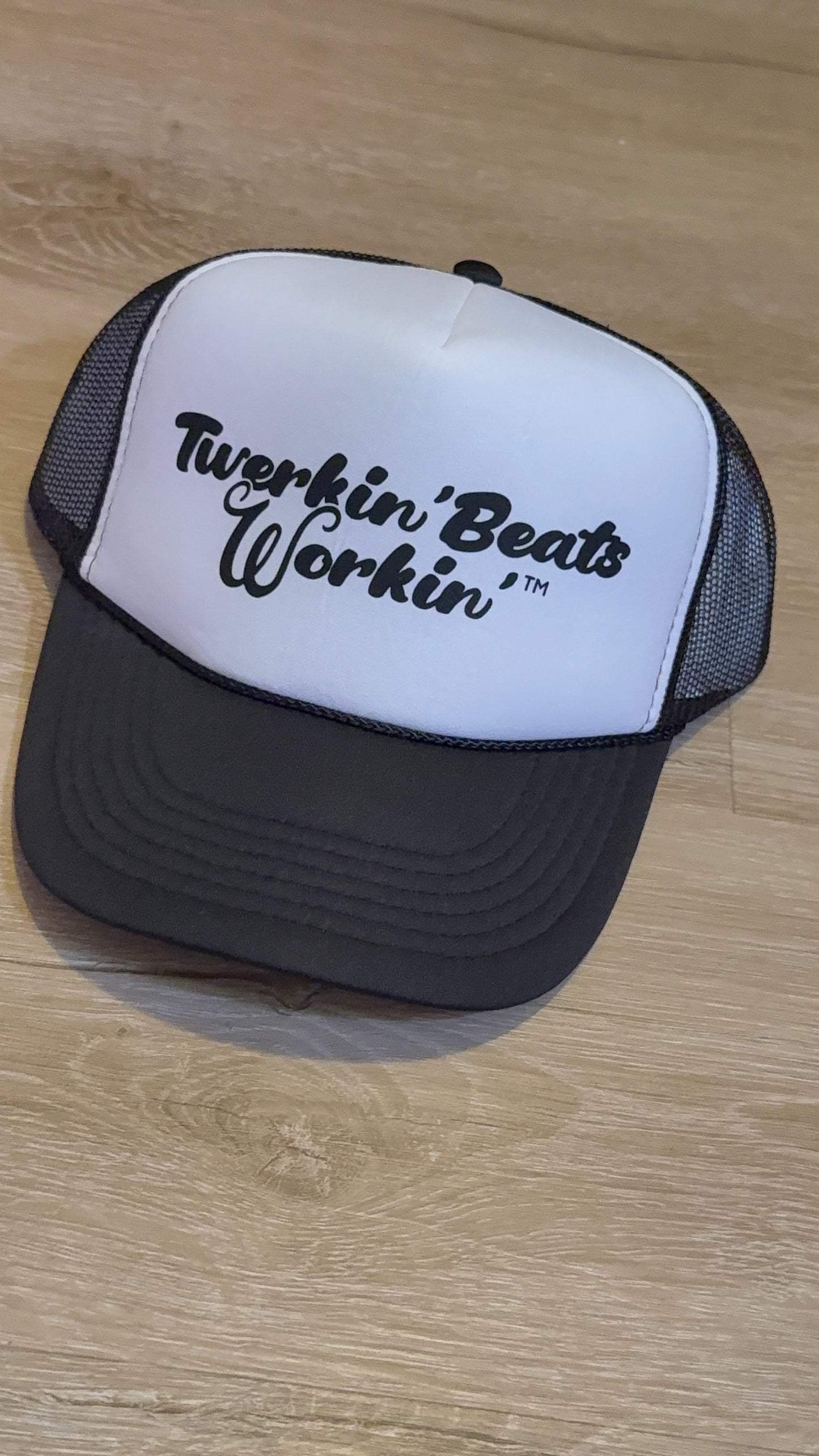 White and black hat with black Twerkin’ Beats Workin’ logo