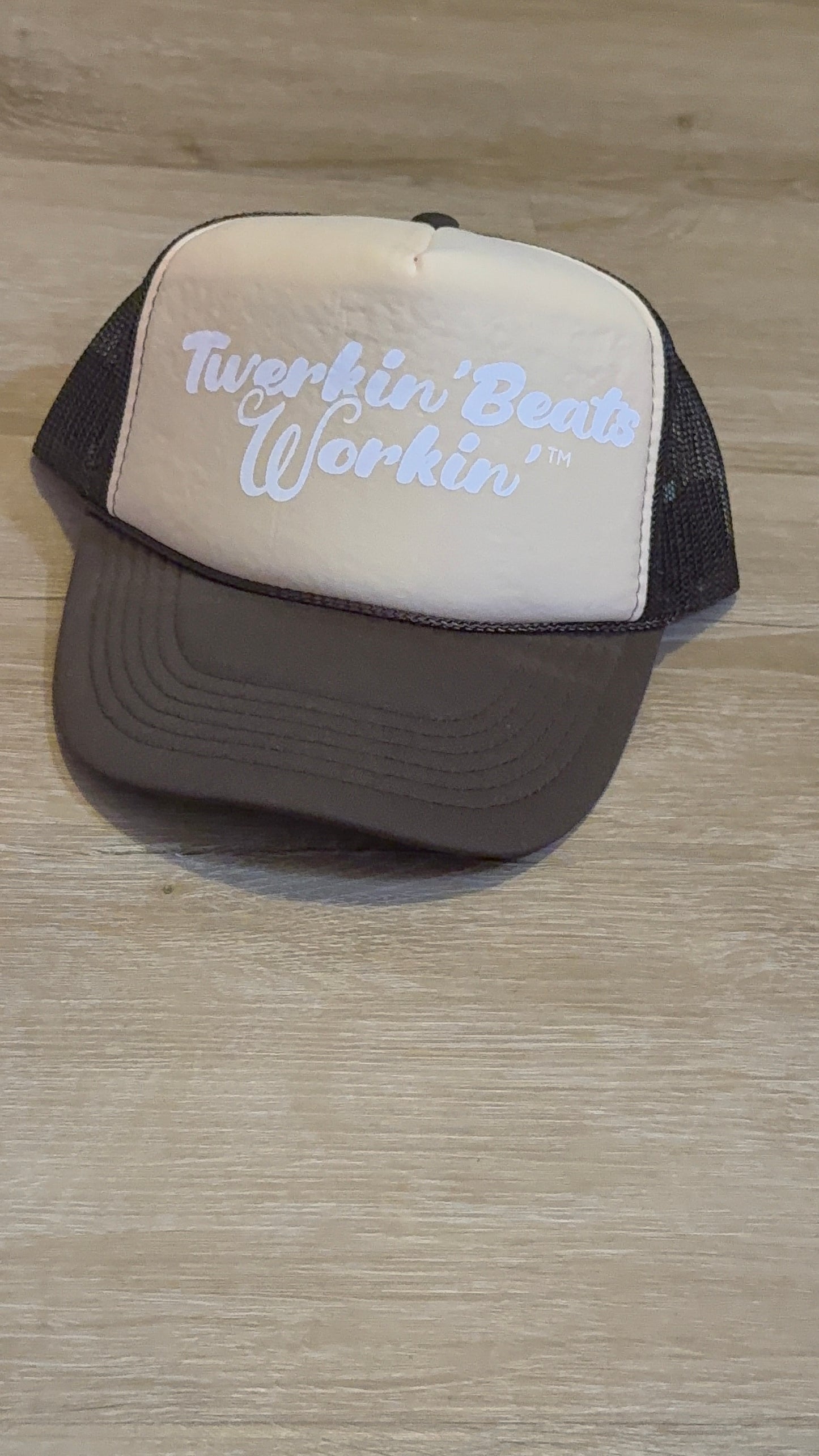 Tan and brown hat with white Twerkin’ Beats Workin’ logo