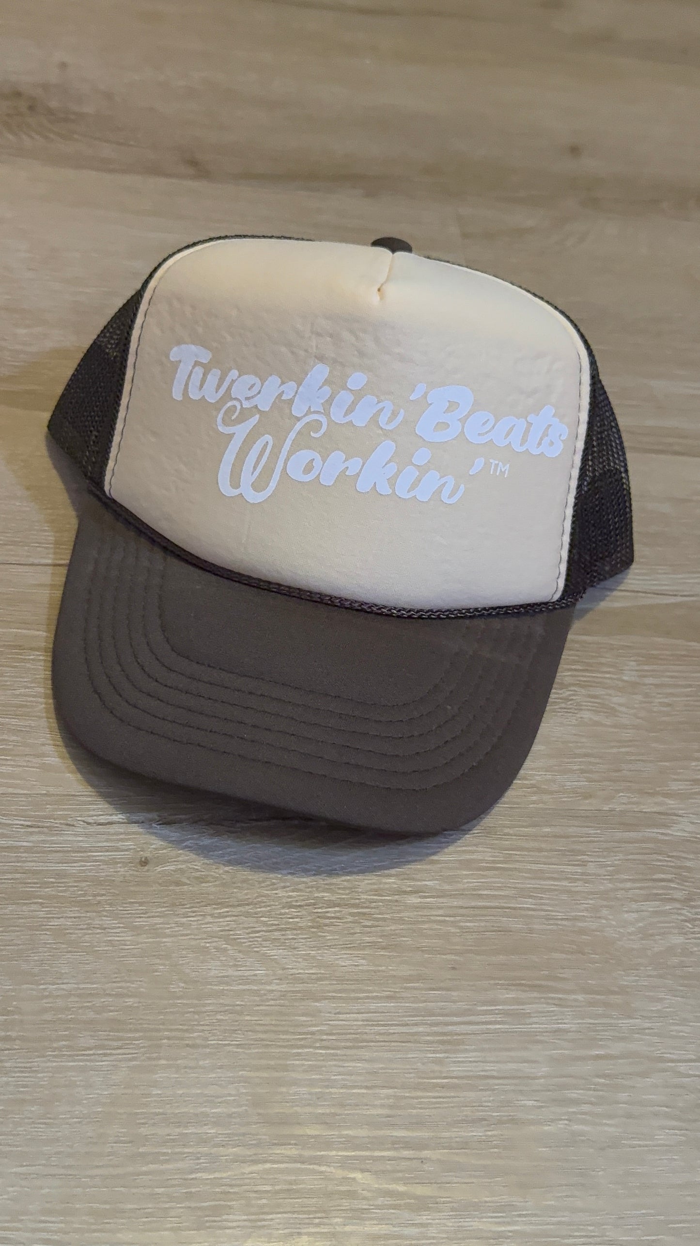 Tan and brown hat with white Twerkin’ Beats Workin’ logo