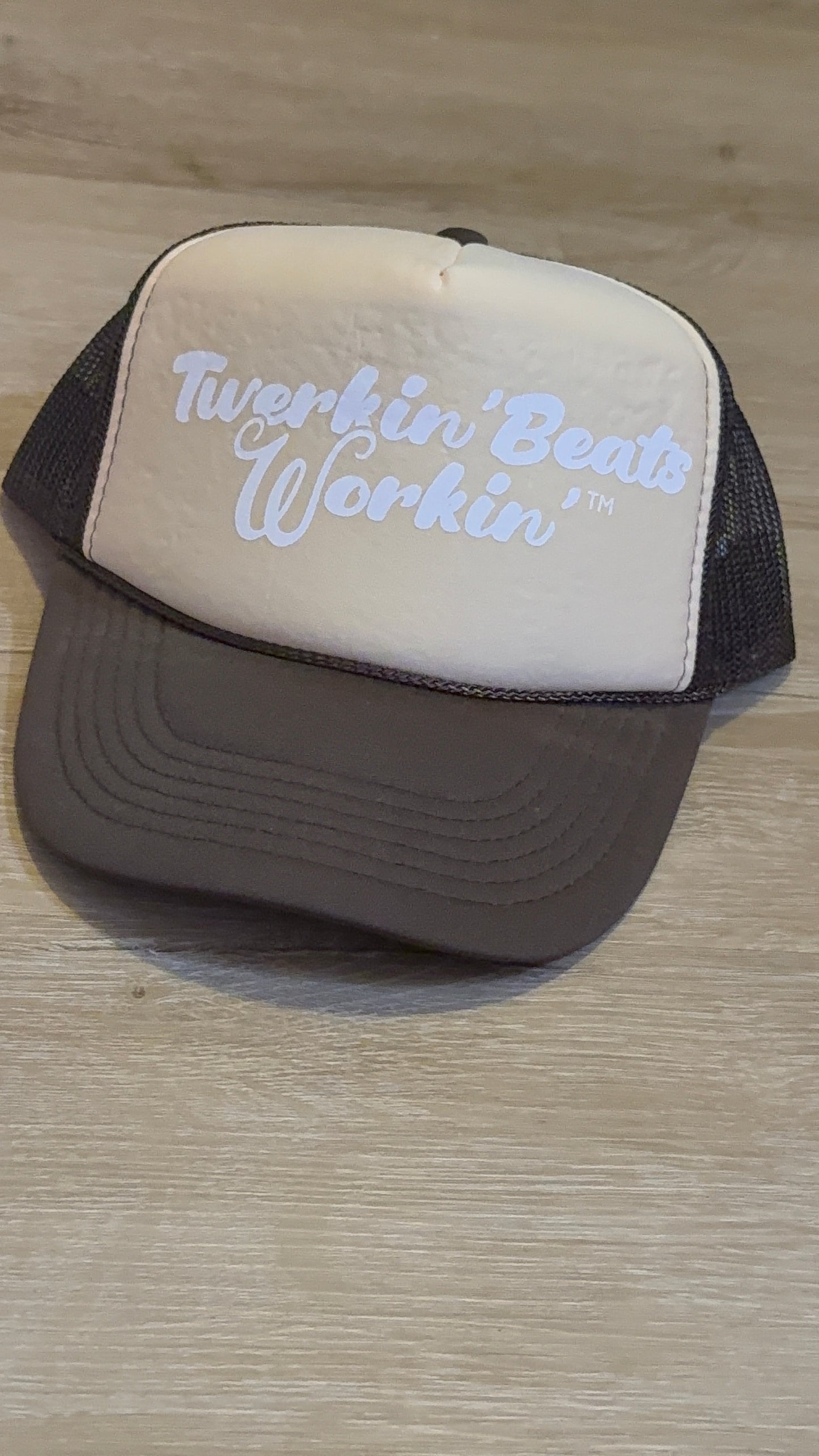 Tan and brown hat with white Twerkin’ Beats Workin’ logo